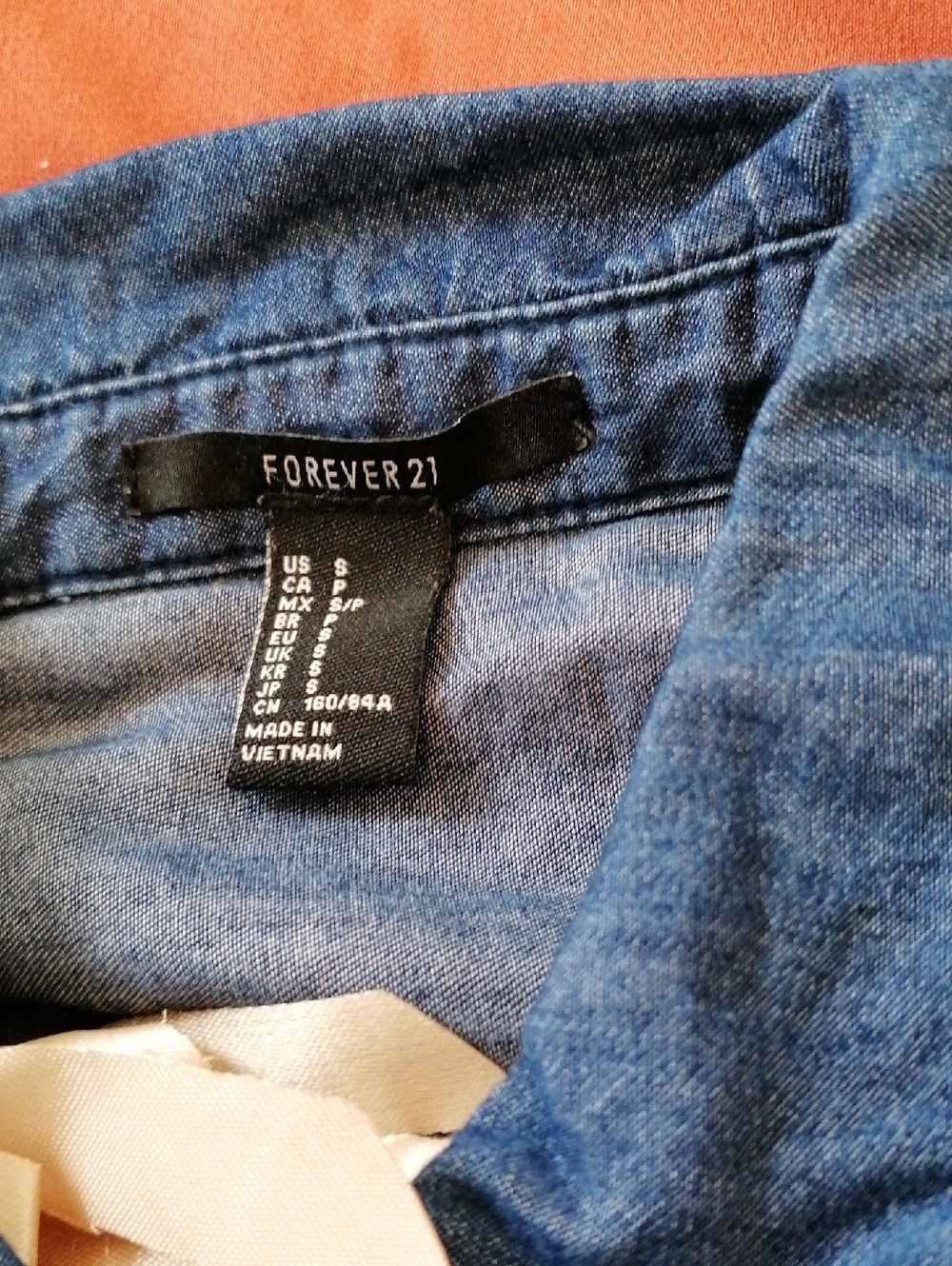 Forever 21 Women's Dark Blue Denim Jeans shirt. Versatile style for everyday.